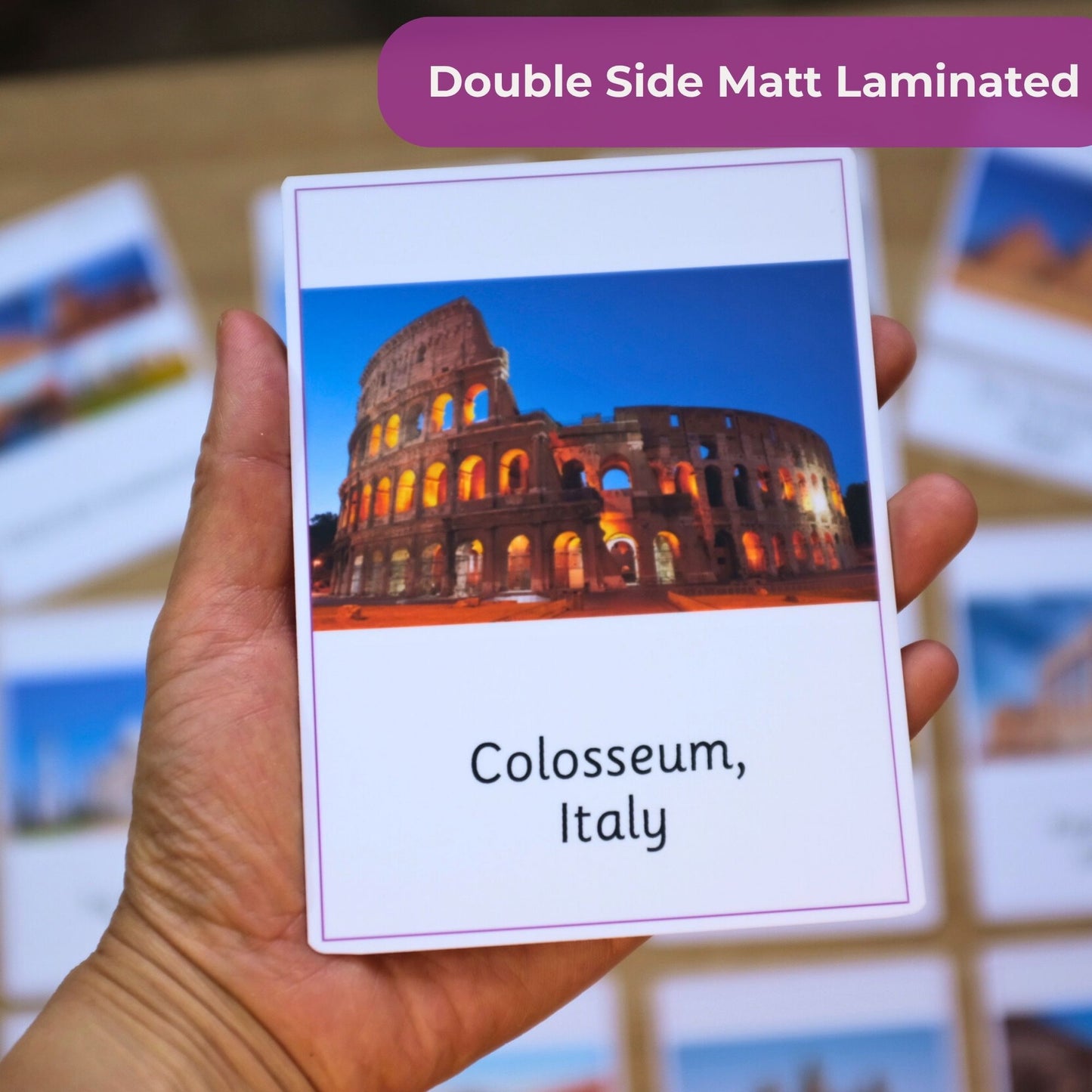Card with Colosseum, Italy design held by a hand against a blurred background of similar cards.