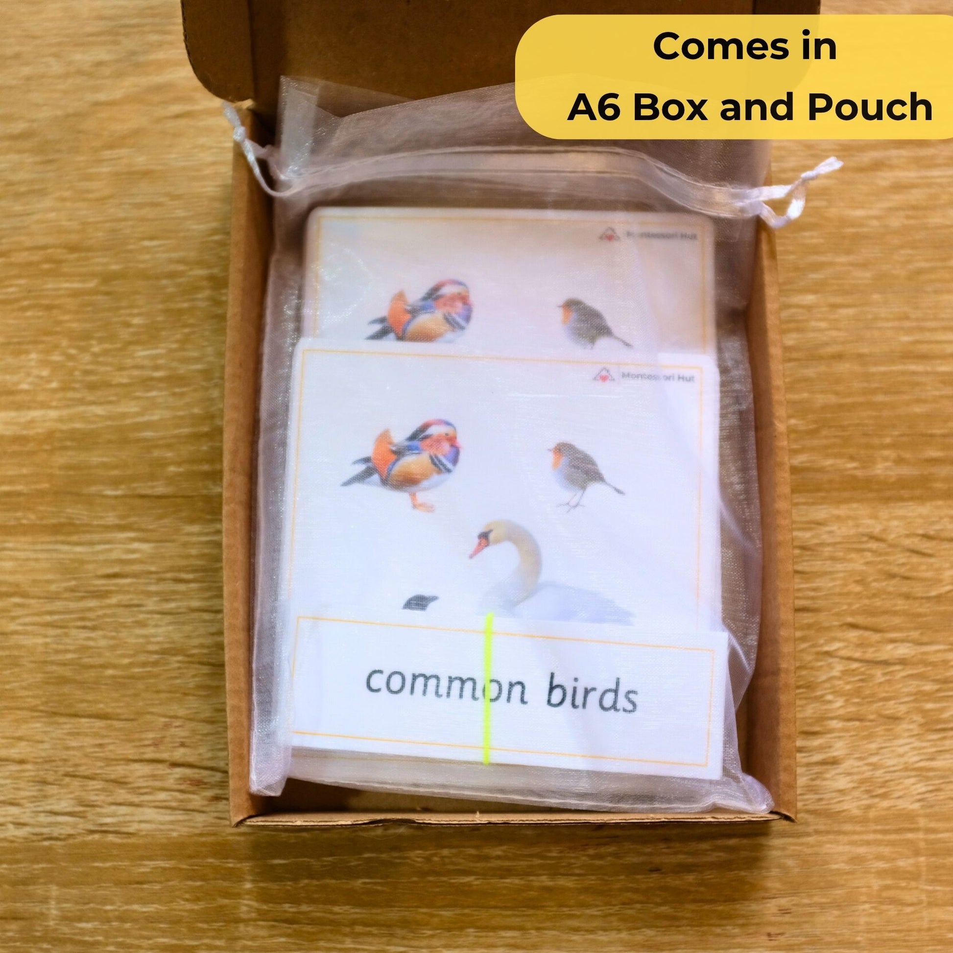 Pack of 'common birds' flashcards in an open box on a wooden surface. - Montessori 3 Part Cards Nomenclature Cards