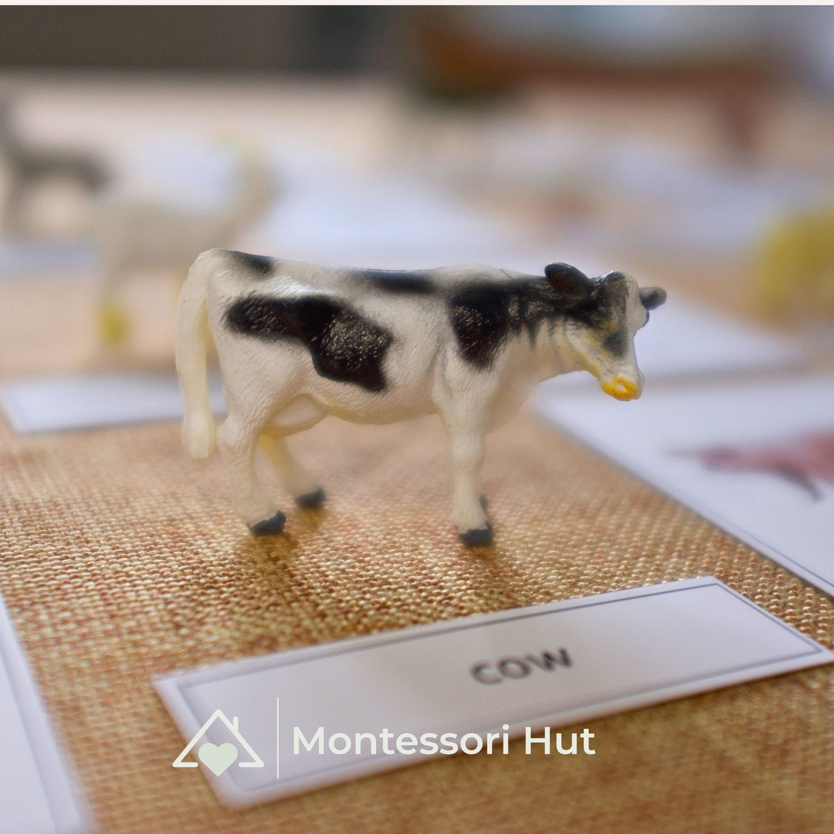 Cow figure standing next to its name label "cow"