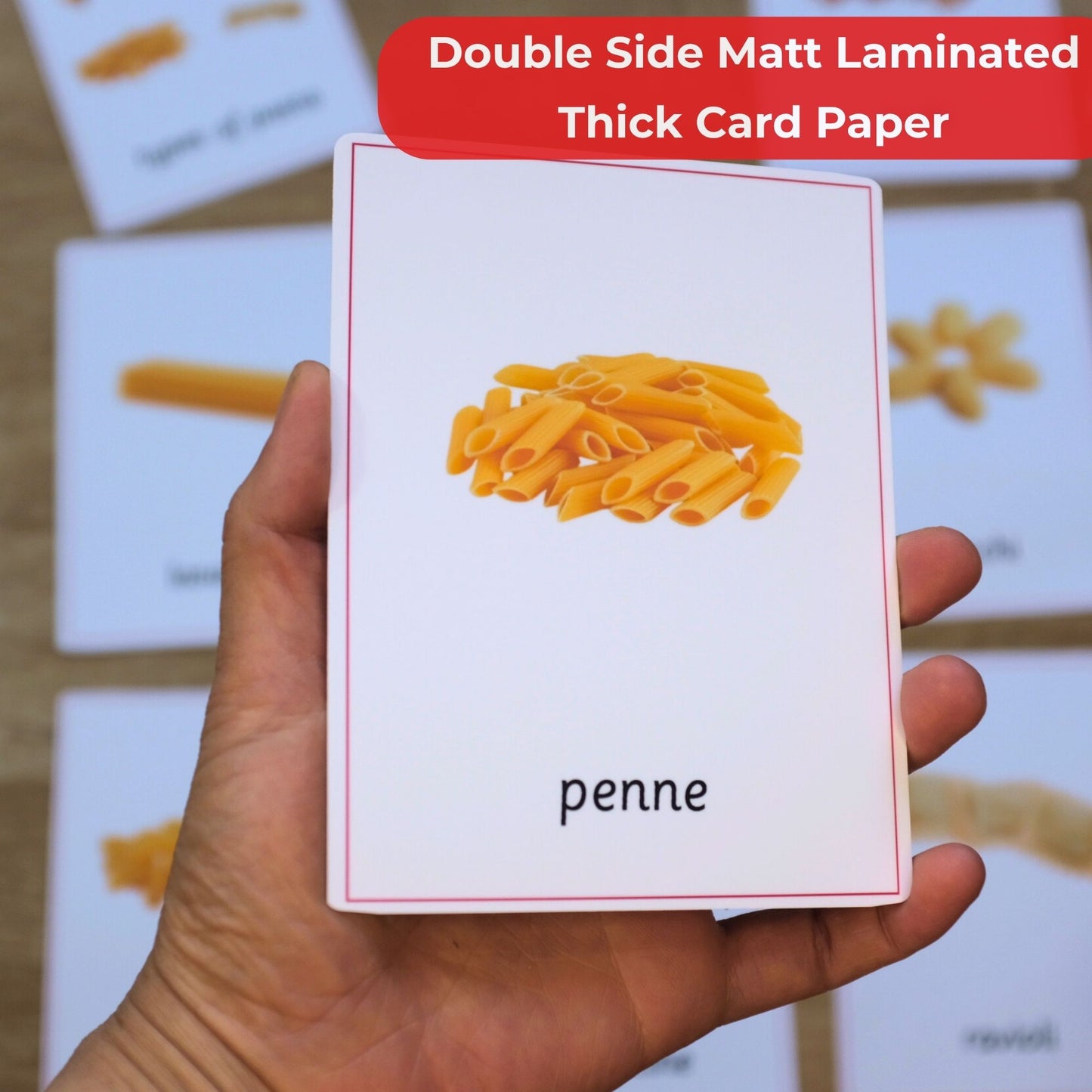 Card with penne pasta illustration held by a hand, on a background of more cards.